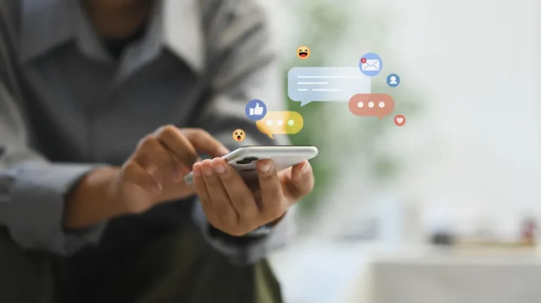 Person holding a smartphone with social media notification icons and message bubbles.